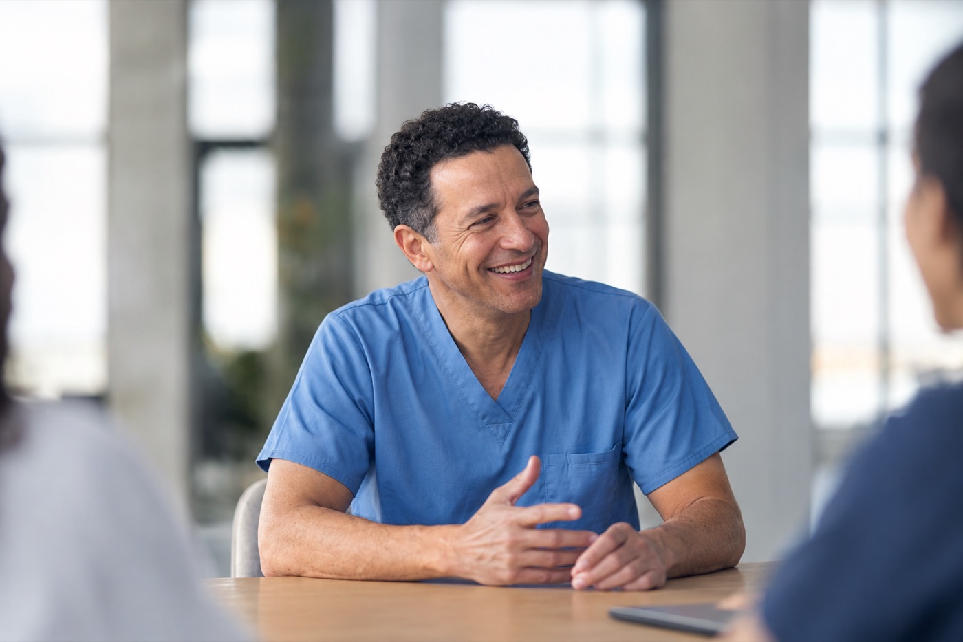 A physician smiling, at ease in conversation